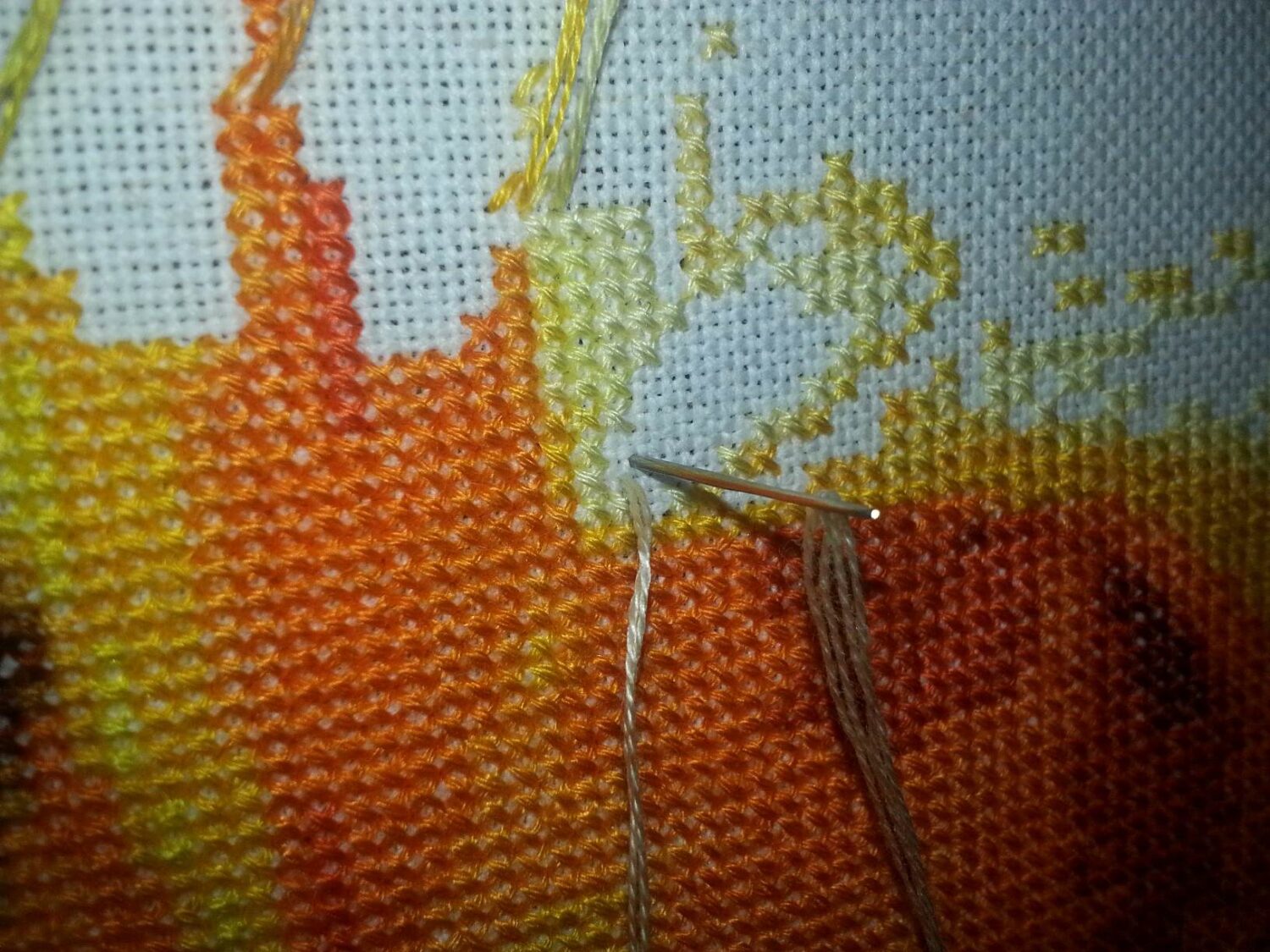 A close up of a pin stitching on a piece of canvas.